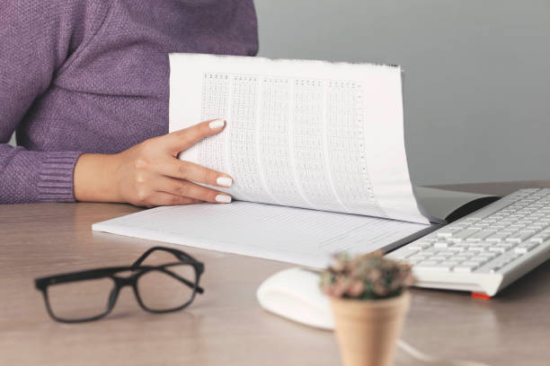 istock woman hand pen with document on working desk 1296015235