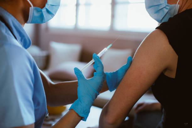 istock Nurse giving vaccine. Close-up. 1296015400