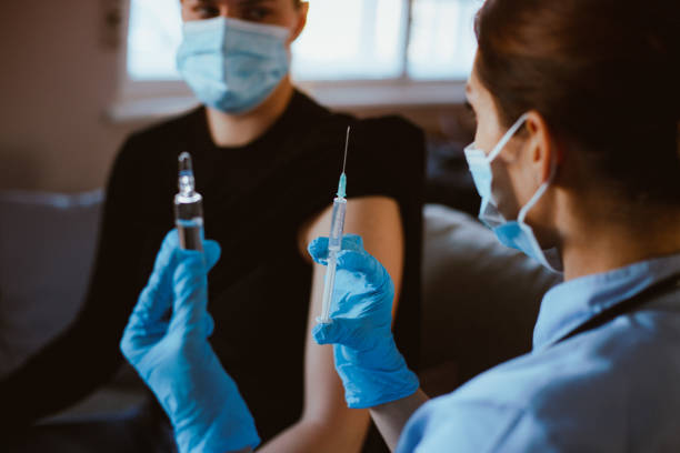 istock Nurse preparing vaccine for patient. 1296015734