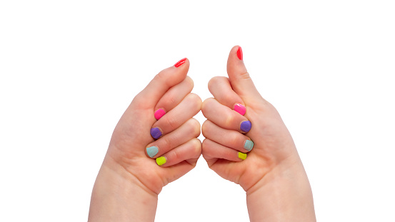 colorful girl's nails isolated on white background, girl's hands with manicure made by girl