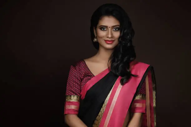 Portrait of beautiful Indian woman wearing traditional sari dress