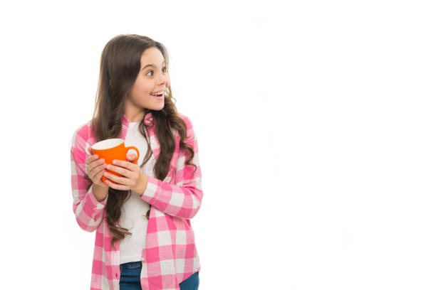 istock It is tea time. Drinking tea. Relaxing with drink. Tea break. Drink enough during school day. Make sure kids drink enough water. Girl surprised face hold cup white background isolated copy space 1296019419