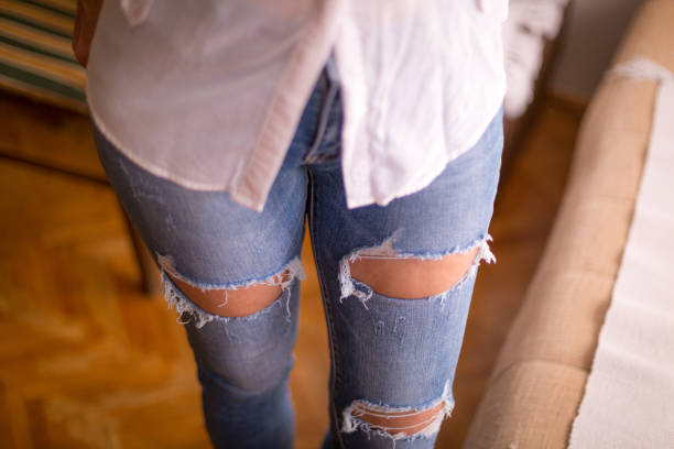 istock Attractive beautiful woman in blue torn jeans 1296021724