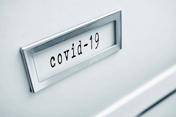 istock archive cardboard box with sticker word : Covid-19 1296021834