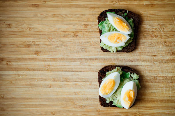 istock Toast with mushed avocado and egg 1296023060