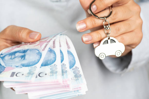 Auto Loan Woman showing Turkish money and car key. car finance stock pictures, royalty-free photos & images
