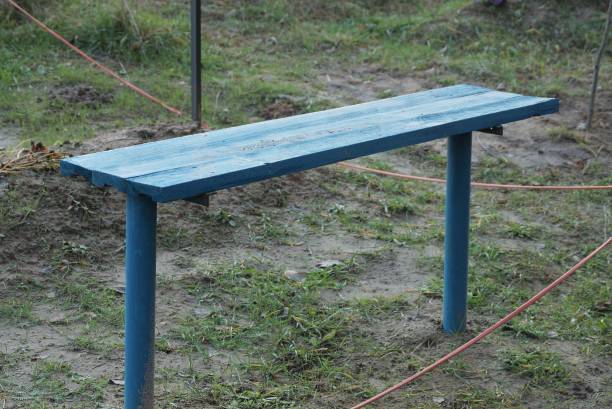 istock one empty blue wooden bench stands on gray ground 1296026930
