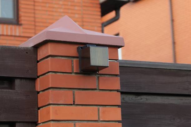 istock one gray square glass signal lantern on red brick fence wall 1296027130