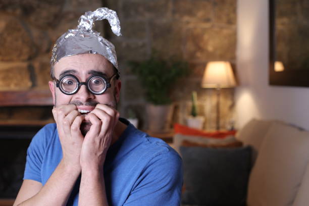 istock Distrustful man wearing weird tinfoil hat 1296028823