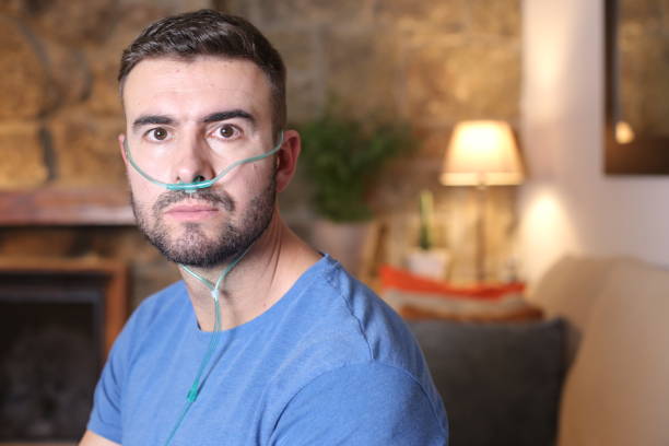 istock Man receiving oxygen through nasal tube 1296029348