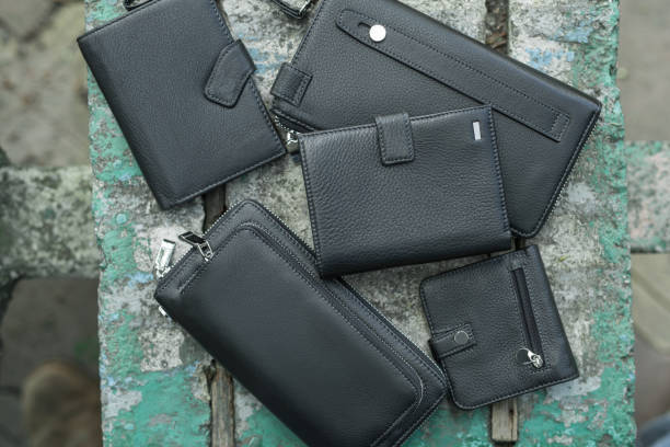 istock Black wallet purse on pavement. White package with no inscriptions. Leatherette wallet. 1296030792