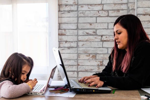 istock Latin woman studying with her daughter at home 1296032675