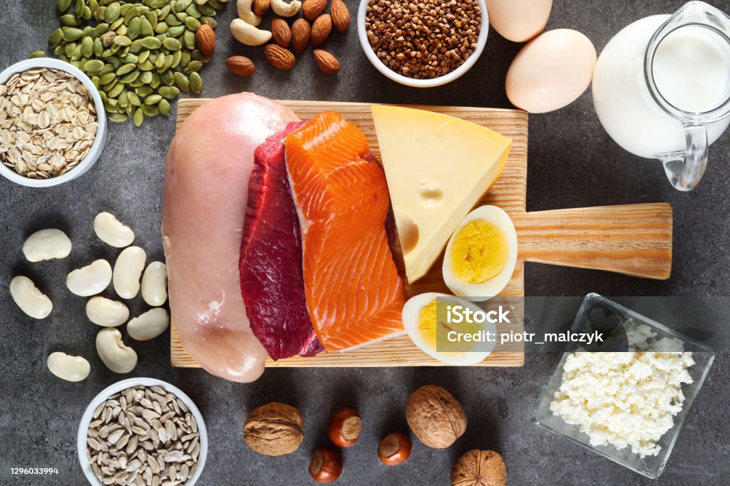 Composition with high protein food High protein food as meat, fish, dairy, eggs, buckwheat, oatmeal, nuts, bean, pumpkin seed and sunflower seed. Top view. Protein Stock Photo