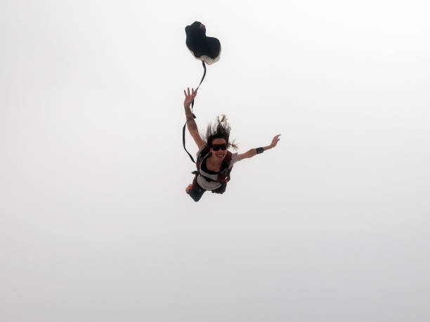 istock A beautiful girl opening her parachute into the clouds. 1296035115