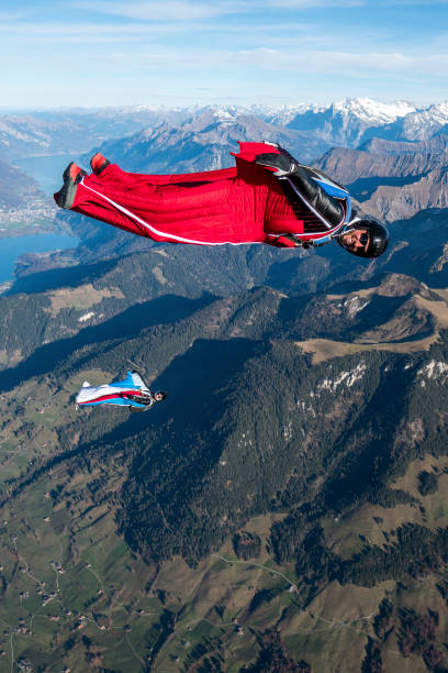 istock Wing suit fliers glide through clear skies 1296035435
