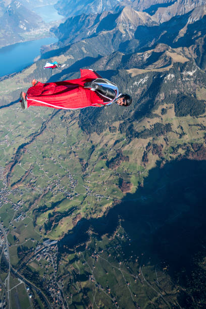 istock Wing suit fliers glide through clear skies 1296035499