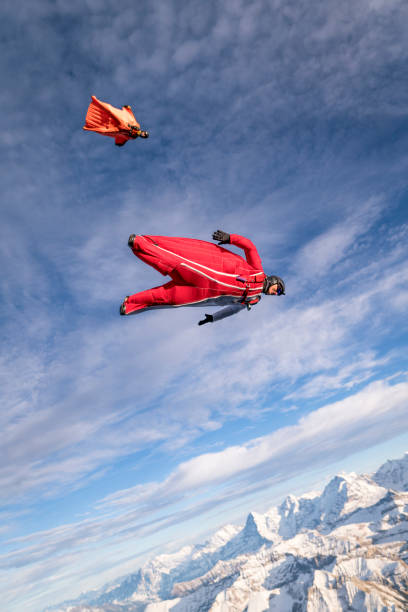 istock Wing suit fliers fall through clear skies 1296036537