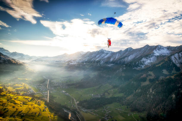 istock Paraglider flies through clear skies in the morning 1296036963