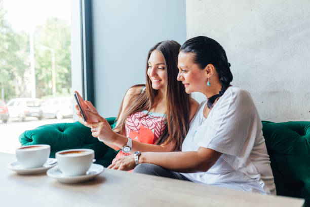 istock Mother And Daughter Women Using A Mobile Phone 1296037002