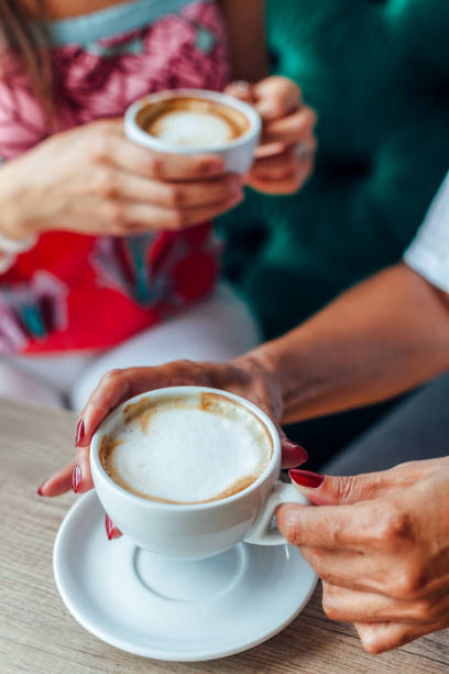 Mother And Daughter Enjoying Coffee
