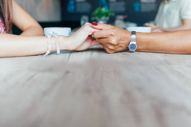 istock Mother And Daughter Women Holding Hands Affectionate 1296037227