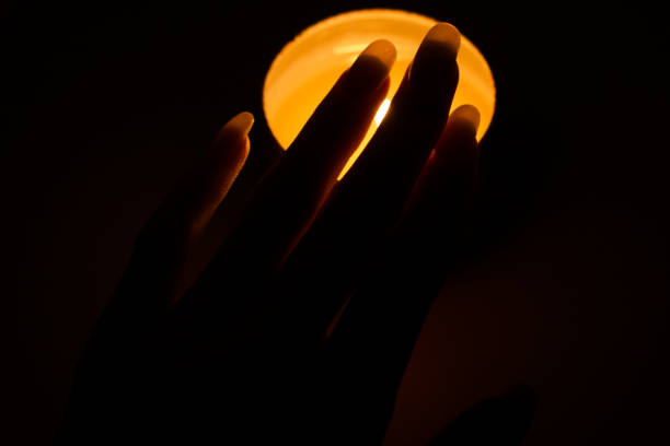 istock Female hand over candle 1296039020