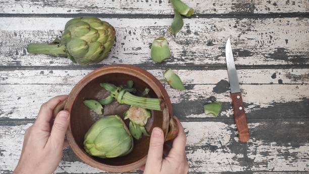 istock Artichokes on a wooden table 1296039049