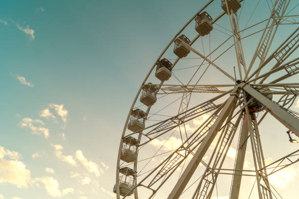 istock View from below of a large ferris wheel in a beautiful sunset. 1296039389