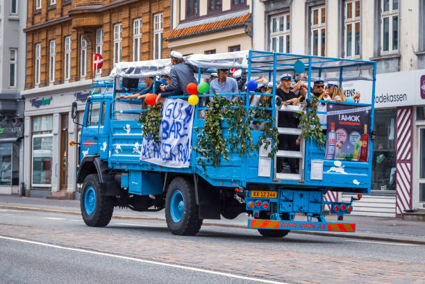 Students in City Aarhus celebrating their graduation Students in City Aarhus celebrating their graduation by driving around in an open top lorry, drinking and visiting each others homes en route danish culture stock pictures, royalty-free photos & images