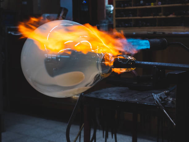 istock Creating traditional glass Art with Hot Torch and glassblowing pipe. 1296040584