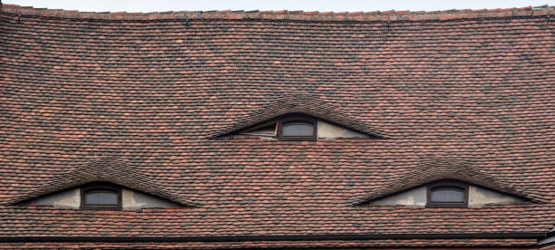 istock Red tile roof with eye-like windows 1296040756