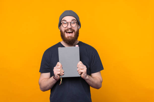 istock Amazed bearded hipster man holding perfect planner for planning time 1296041582
