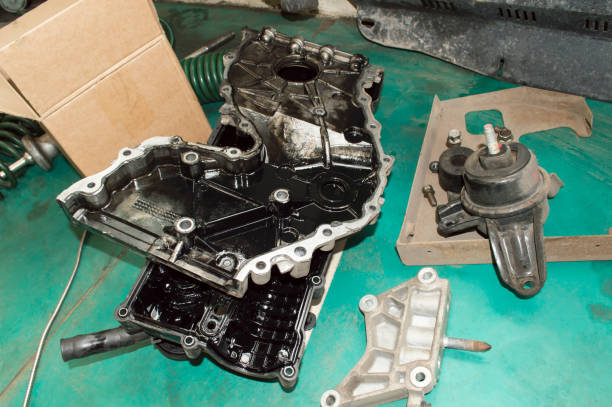 istock Engine covers lie on the green floor in the garage 1296042133