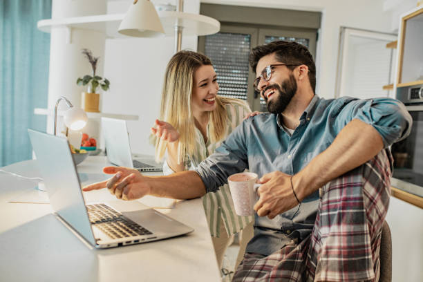 istock A young couple is working late from home on their laptops 1296043677
