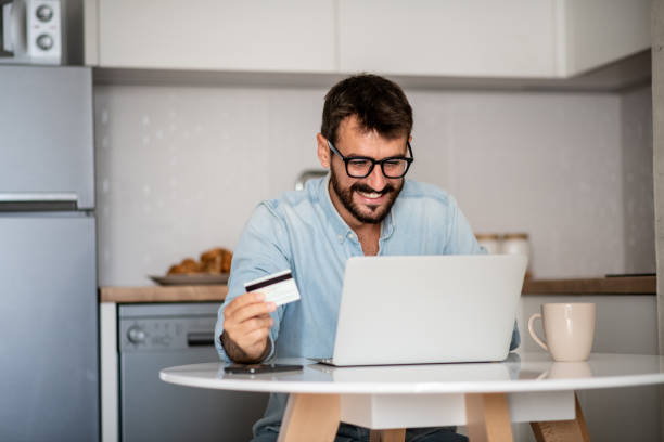istock Young hipster is using credit card, buying online. 1296046428