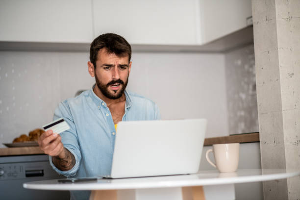 istock Young man confused. He failed to pay online. 1296046454