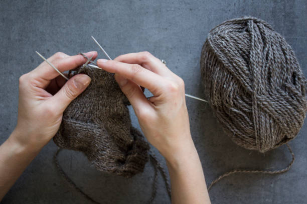 istock Woman knits warm socks 1296046567