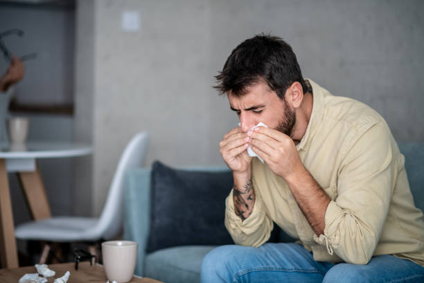 istock Young man wiping his nose. 1296046575