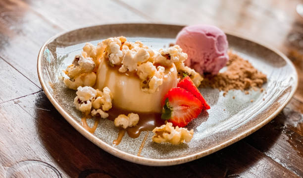 Pannacotta with strawberry ice cream and pop corn with sea salted caramel Portugal photography high angle view - fotografia de stock