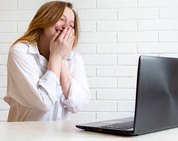 istock young cheerful girl communicates remotely online and laughs 1296047571