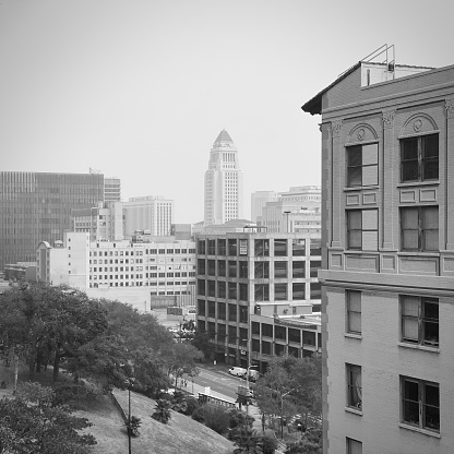 Los Angeles, CA, Sep 2020: City Hall seen from near apartment buildings at Bunker Hill in Downtown on a hazy day, black and white