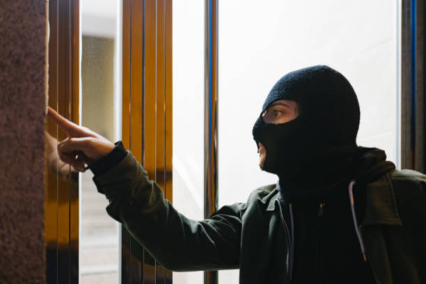 istock Thief with mask ringing the doorbell 1296049661