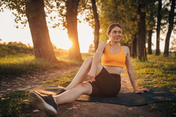 istock Fit woman exercising on exercise mat in nature 1296056481