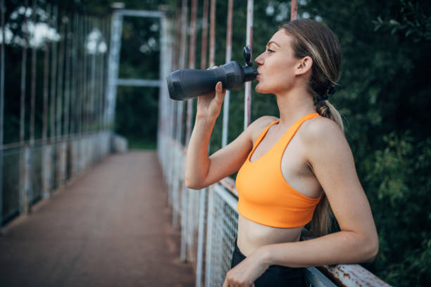 istock Fit woman taking a water break after training 1296056558