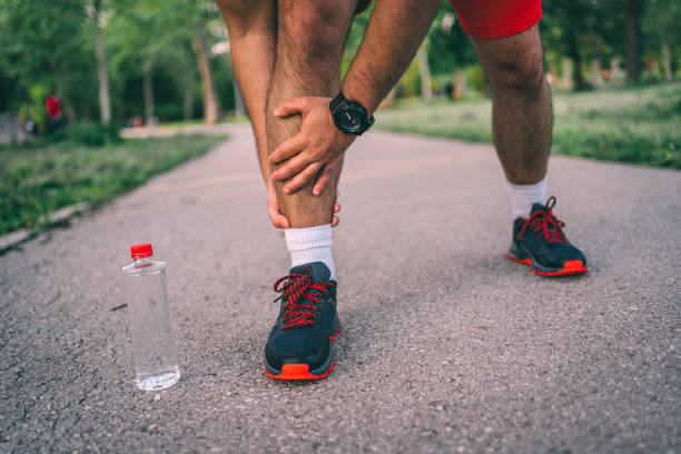 istock Man suffers from leg injury while exercising 1296057339