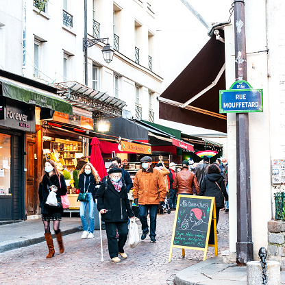 People wearing a mask for prevent coronavirus in Paris, rue Mouffetard in Quartier Latin. France. January 9, 2021.