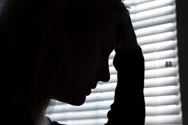 istock Silhouette of a Depressed Woman's Profile 1296060277