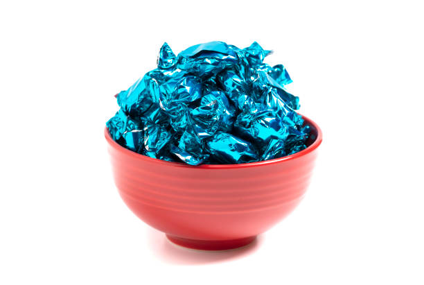 A Bowl of Blue Wrapped Candy Isolated on a White Background