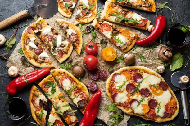 istock Close up cutted artisan pizzas with wine 1296060407