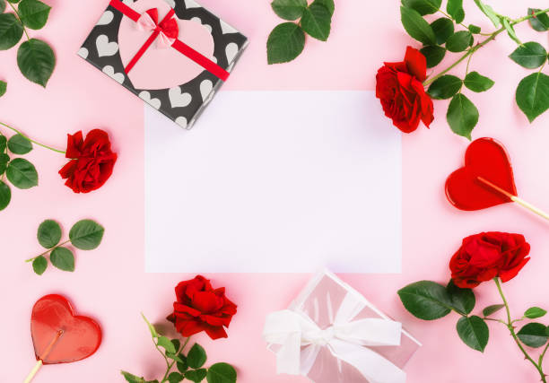 istock Valentine's day or Birthday background with gift boxes, rose, heart shape candy and white sheet of paper for writing, top view. Flat lay composition with copy space for text. 1296061088